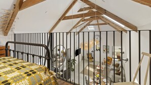 A room with a bed, a desk, a chair, and a window. - Stylish barn conversion, sleeps 5, with hot tub (Carmarthen)