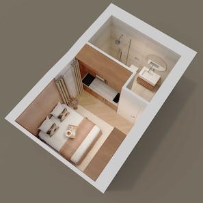 Een moderne hotelkamer met een bed, een zithoekje en een badkamer met douche en wastafel.