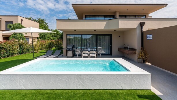 A modern house with a swimming pool, a barbecue area, and a dining setup. - Exclusive Ground-Floor Apartment with Private Pool and Terrace in Istria (Brtonigla)