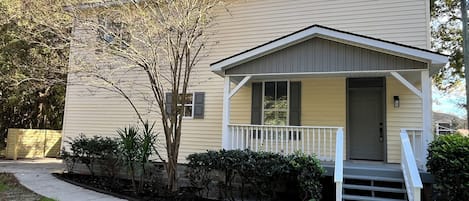 A single-story house with a front porch, a small staircase leading to the entrance, and a well-maintained lawn.