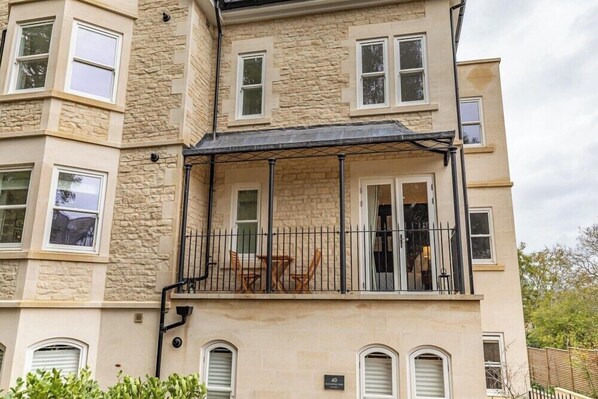 Enjoy the view from the balcony with a table and two chairs.
