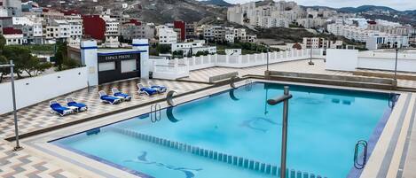 Outdoor pool, open 10:00 AM to 6:00 PM, pool umbrellas, sun loungers