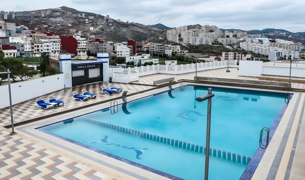 Outdoor pool, open 10:00 AM to 6:00 PM, pool umbrellas, sun loungers