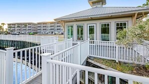A modern hotel with a pool area, white railings, and a view of other buildings. - 🌴Walk to Beach-3BR-Lake View-Seagrove Highlands 1304🌴 (Santa Rosa Beach)