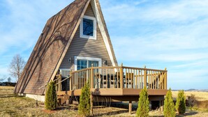 A triangular house with a wooden deck and a small window. - 🏠 Mid-Century A-Frame Near Galena | Stargaze | Couples Retreat | 1 Bed/1 Bath (Elizabeth)