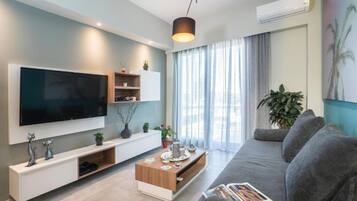 Luxury Apartment, City View | Living area | 55-inch Smart TV with satellite channels, video game console