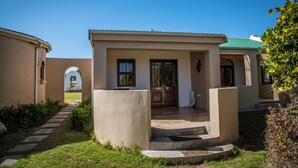 A two-story building with a covered entrance and a small porch. - Grootvlei Guest Farm (Cederberg)