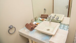 A bathroom with a sink, mirror, towel rack, and toiletries. - Grootvlei Guest Farm (Cederberg)