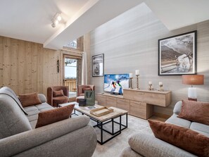 A modern living room with a sofa set, a coffee table, a TV, and a wooden cabinet.
