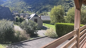 A view of a mountain village with traditional houses and a clear sky.