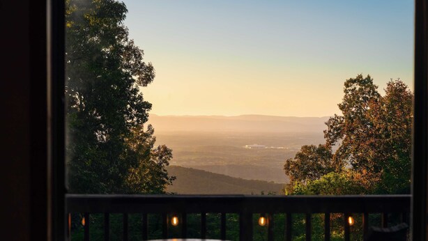 A balcony with a view of a valley and distant mountains. - Wilderness Ridge | Private Cabin w/ Mountain Views (Linden)