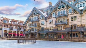 A hotel with a traditional architectural style, featuring multiple balconies and large windows. - Auberge Resort 5 Star Residence (Mountain Village)