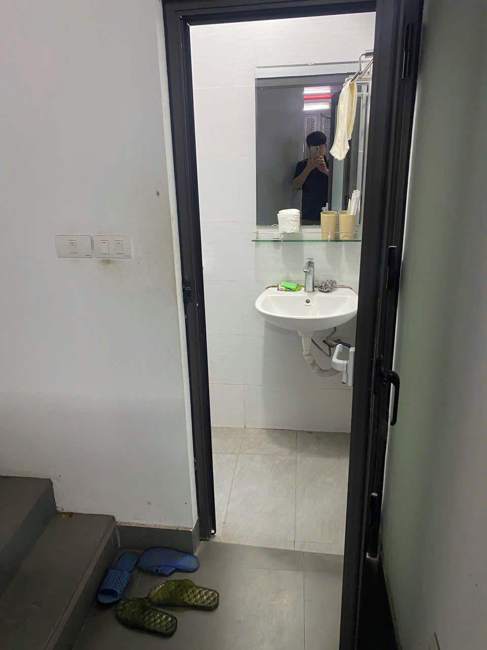 A bathroom with a sink, mirror, and towel rack.