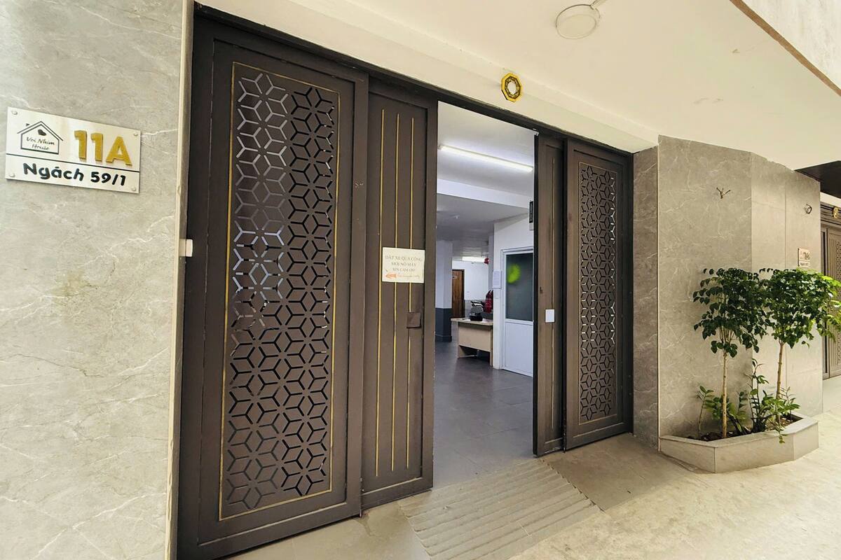 Entrada de hotel con diseño moderno, incluyendo un patrón geométrico en la puerta y un cartel que indica la habitación 11A.