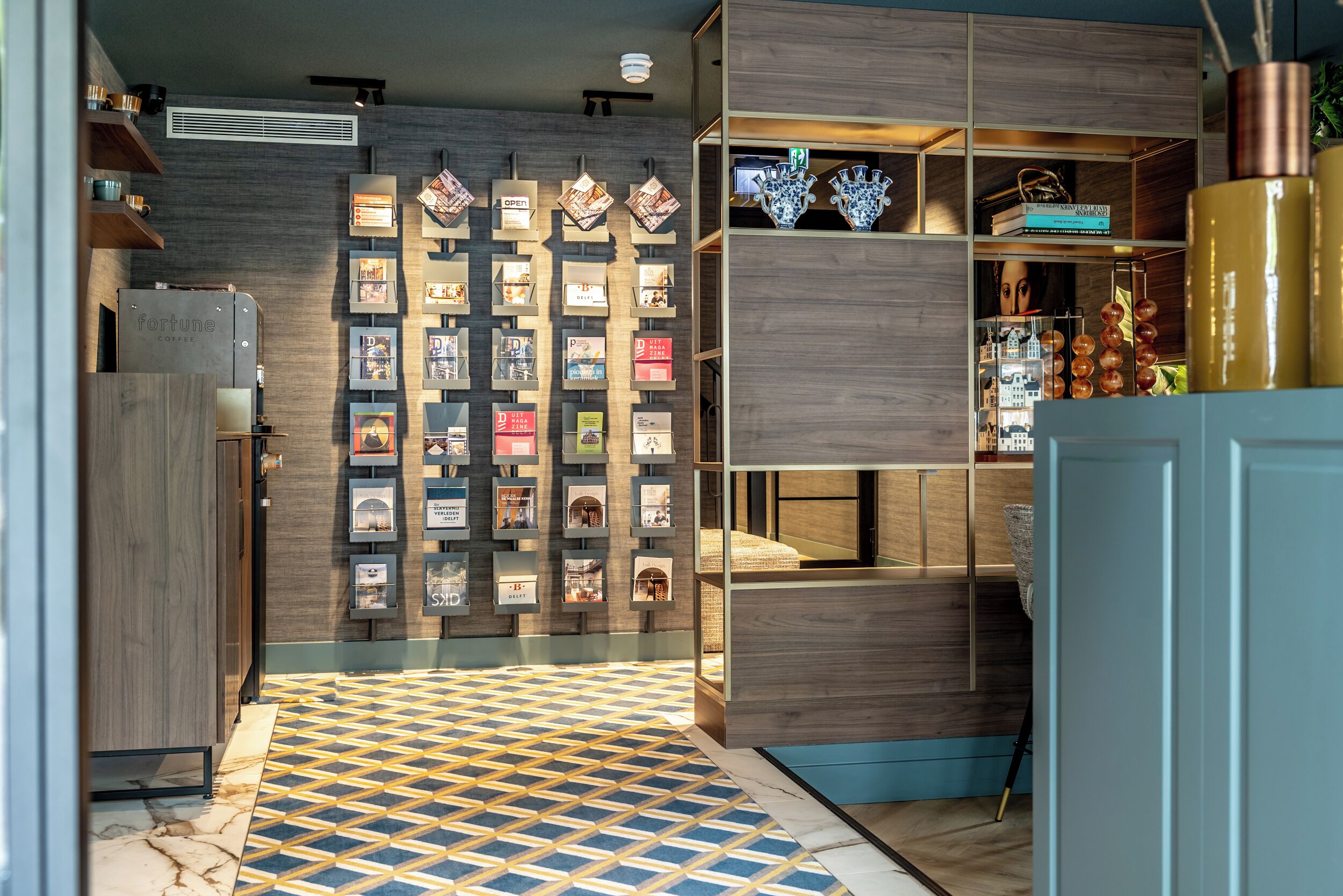 A modern interior with a patterned floor, wooden shelving, and a display of promotional materials.