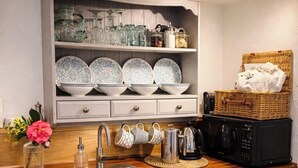 A kitchen with a wooden countertop, a stainless steel sink, white cabinets, and a microwave. - Cornwall Getaway for two - The Loft (Saint Kew)