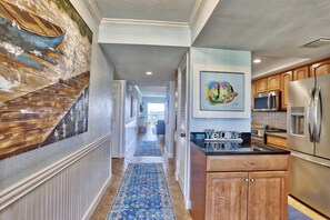 Enjoy cooking in this well-equipped kitchen with a central island, stainless steel appliances, and ample cabinetry.