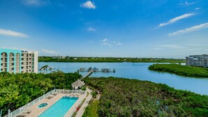 A hotel with a pool, a dock, and a view of a river. - Dolphin Key 504 - Premier (Indian Shores)