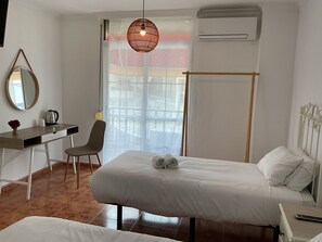 Enjoy a comfortable stay in this stylish room featuring a bed, desk, and large window with an outside view.