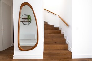 A staircase with wooden steps and a wooden handrail.