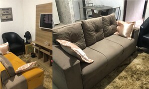 Relax in this stylish living room with a comfortable sofa, side table, and office chair.