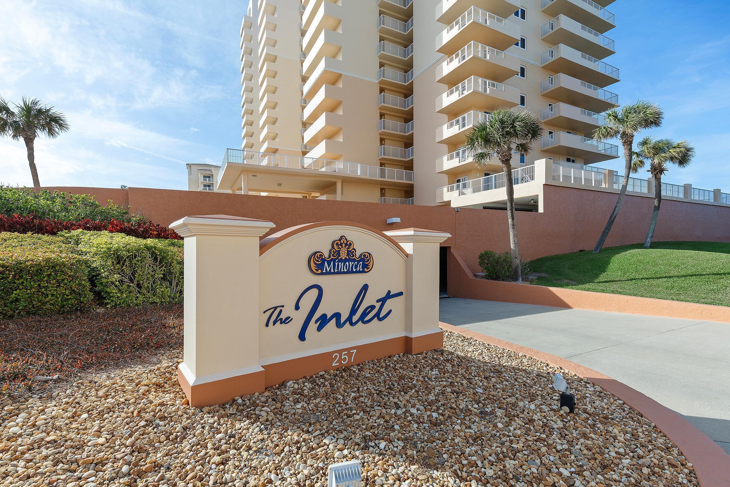A hotel entrance sign with the name "The Inlet" and the number "257".