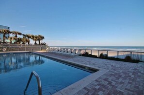 A swimming pool with a view of the beach and ocean. - Malibu 704 (New Smyrna Beach)