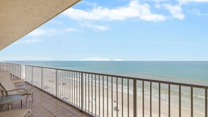 A balcony with a view of the beach and ocean. - Malibu 803 (New Smyrna Beach)