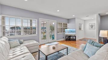 Casa, varias camas (Ocean's Edge) | Área de sala de estar | Televisión