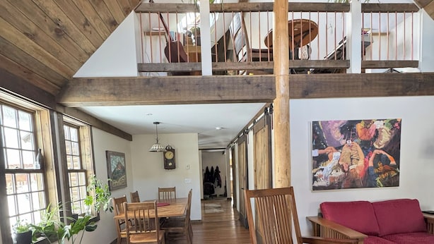 A spacious loft with high ceilings, wooden floors, and a mezzanine level. - Beautiful vacation house in the middle of Crested Butte (Crested Butte)