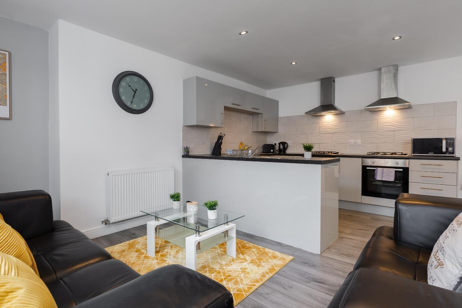 A modern apartment with a living room, kitchen, and dining area.