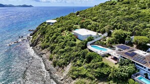 A coastal property with a swimming pool, solar panels, and lush greenery. - Waterfront,Private home&pool,Breathtaking Views,Great Location. Enjoy paradise! (St Thomas)