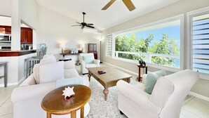 A spacious living room with a ceiling fan, large windows, and a view of greenery. - Waterfront,Private home&pool,Breathtaking Views,Great Location. Enjoy paradise! (St Thomas)