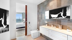 A modern bathroom with a large mirror, a sink with two basins, and a toilet. - Luxurious 2BR/2.5BA Unit on Simpson Bay Beach (Simpson Bay)