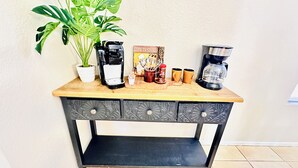 A wooden coffee table with two coffee makers, a potted plant, and kitchen utensils. - Tucson two story 4BR  2.5BA house close to airport & major attractions Sleeps 8 (Tucson)