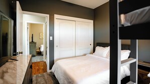A bedroom with a bed, a dresser, a mirror, a wardrobe, and a bunk bed. - 5 Bedroom House in Beautiful SW Bakersfield - HWY 99 Access (Bakersfield)