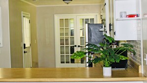 A kitchen with a wooden countertop, a potted plant, and a refrigerator. - RANCH RETREAT, Beautiful 3-bedroom house in Columbus, MS (Columbus)