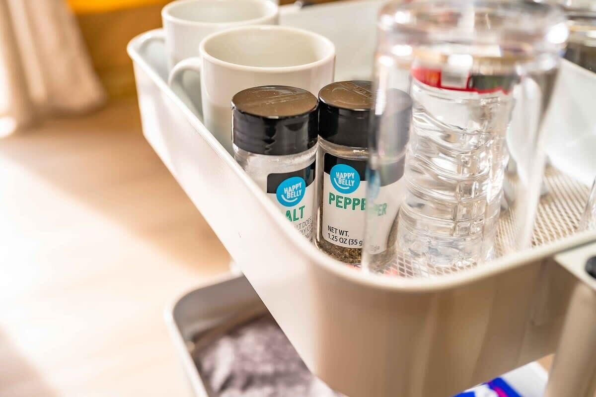 A tray with salt, pepper, and water bottles, along with a mug.