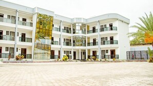 A multi-story hotel with a central courtyard, balconies, and a glass facade. - Wils Hotel SUpreme (Lusaka)