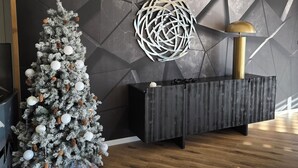 A modern living room with a Christmas tree, a geometric wall design, and a wooden floor. - Loft Eclipse 1723 (Font-Romeu-Odeillo-Via)