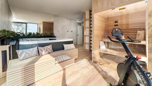 A modern spa room with a wooden bench, a sauna, and a treadmill.