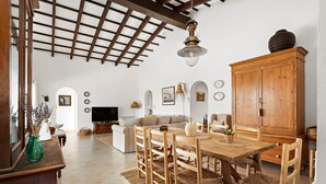A spacious living room with a wooden dining table, chairs, and a large cabinet. - Villa Bini Yaya 8 - Cap den Font (Cap d´en Font)