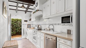 A modern kitchen with white cabinetry, a dishwasher, a microwave, and a sink. - Villa Bini Yaya 8 - Cap den Font (Cap d´en Font)