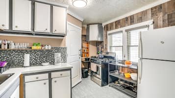 Fridge, microwave, coffee/tea maker, cookware/dishes/utensils