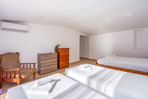 A hotel room with a single bed, a chair, a dresser, and an air conditioning unit. - #278 Fonte dos Leões by Home Holidays (Albufeira)