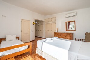 A hotel room with two beds, a wooden dresser, a mirror, and a wardrobe. - #278 Fonte dos Leões by Home Holidays (Albufeira)