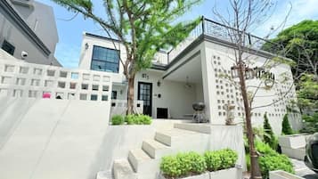 A modern building with a staircase leading to a door marked 'BTS'.