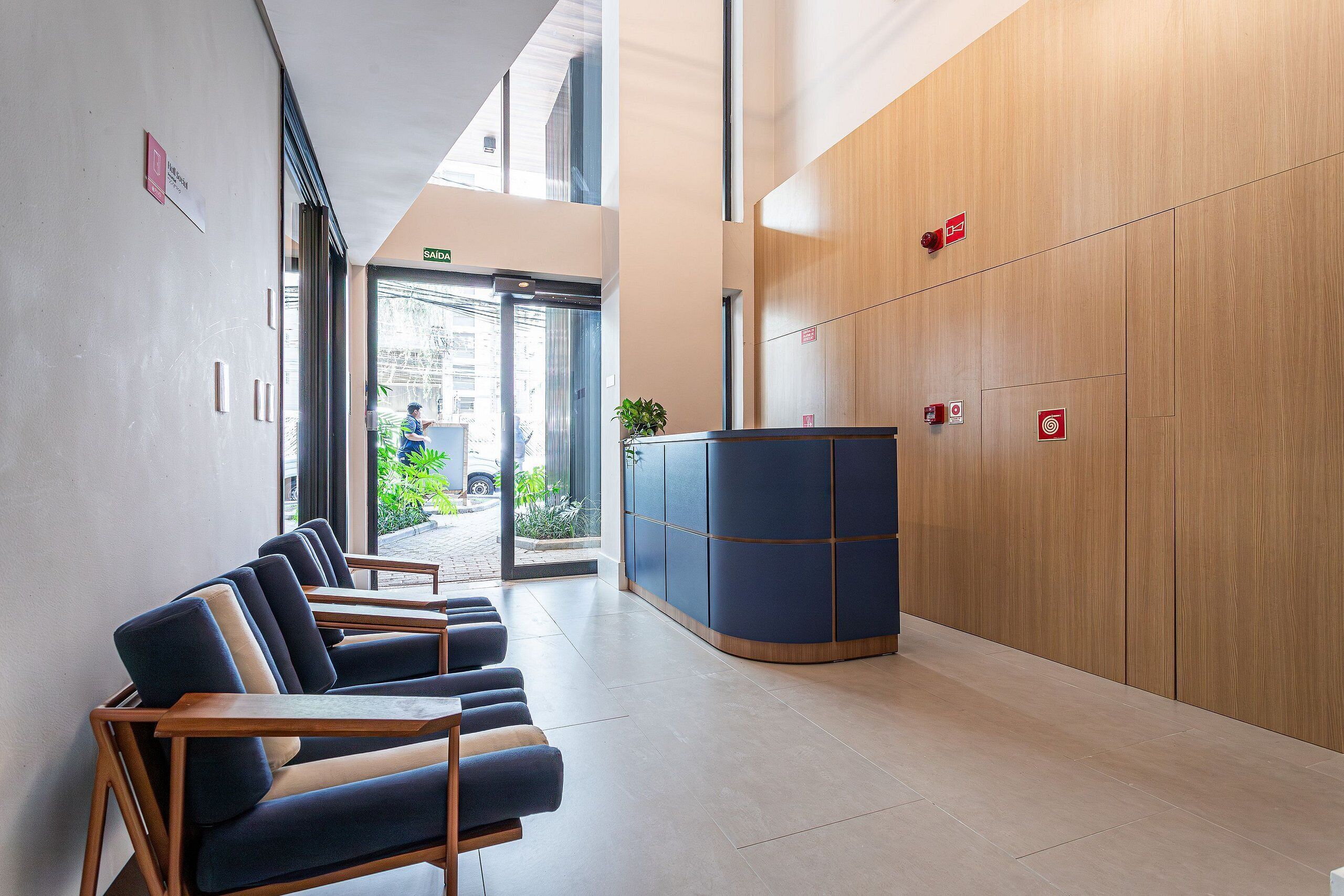 A reception area with a counter, seating, and a view of the outside.