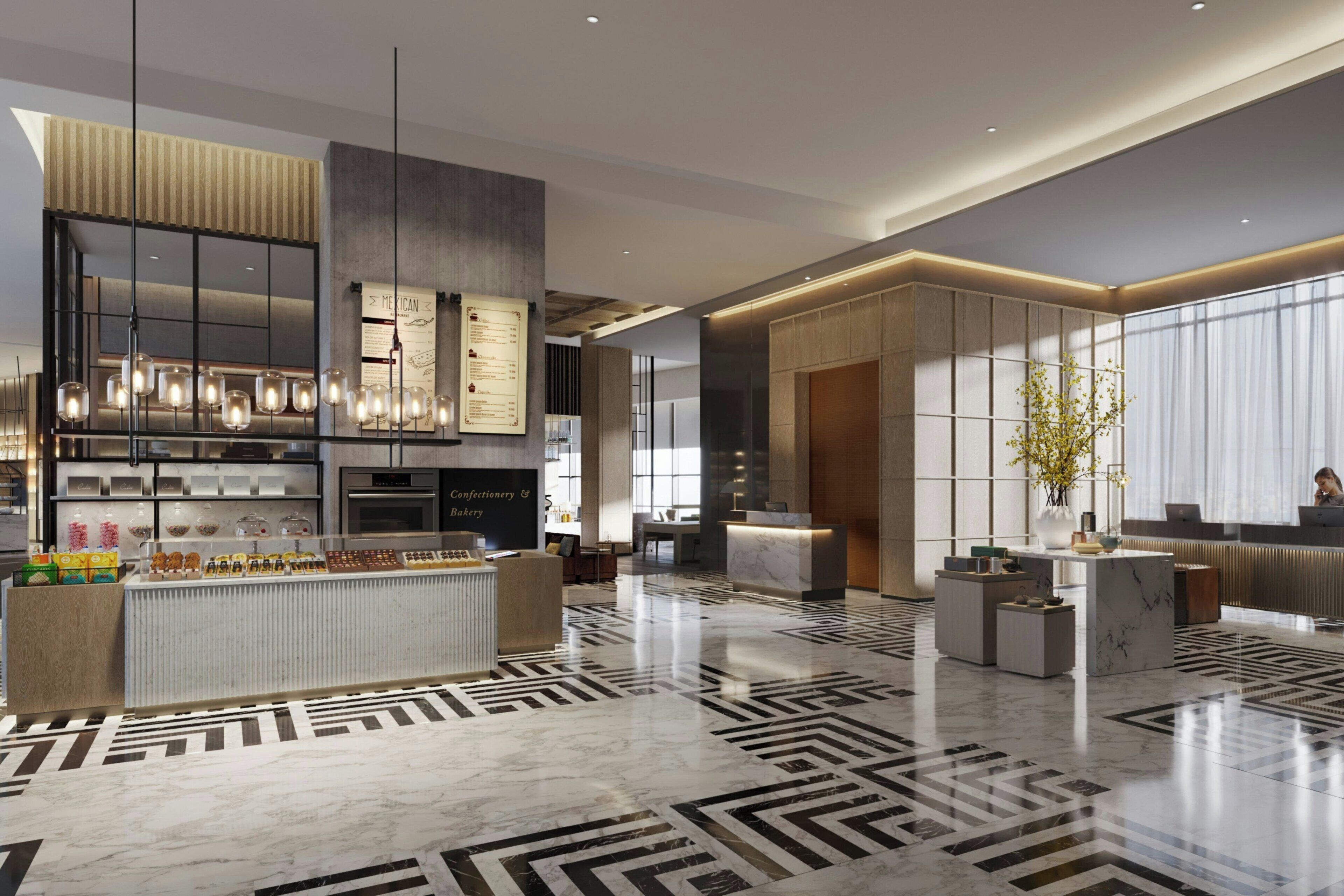 Eine moderne Hotelhalle mit einer zentralen Rezeption, einer Küchenzeile und einer Sitzecke mit einem gemusterten Boden.