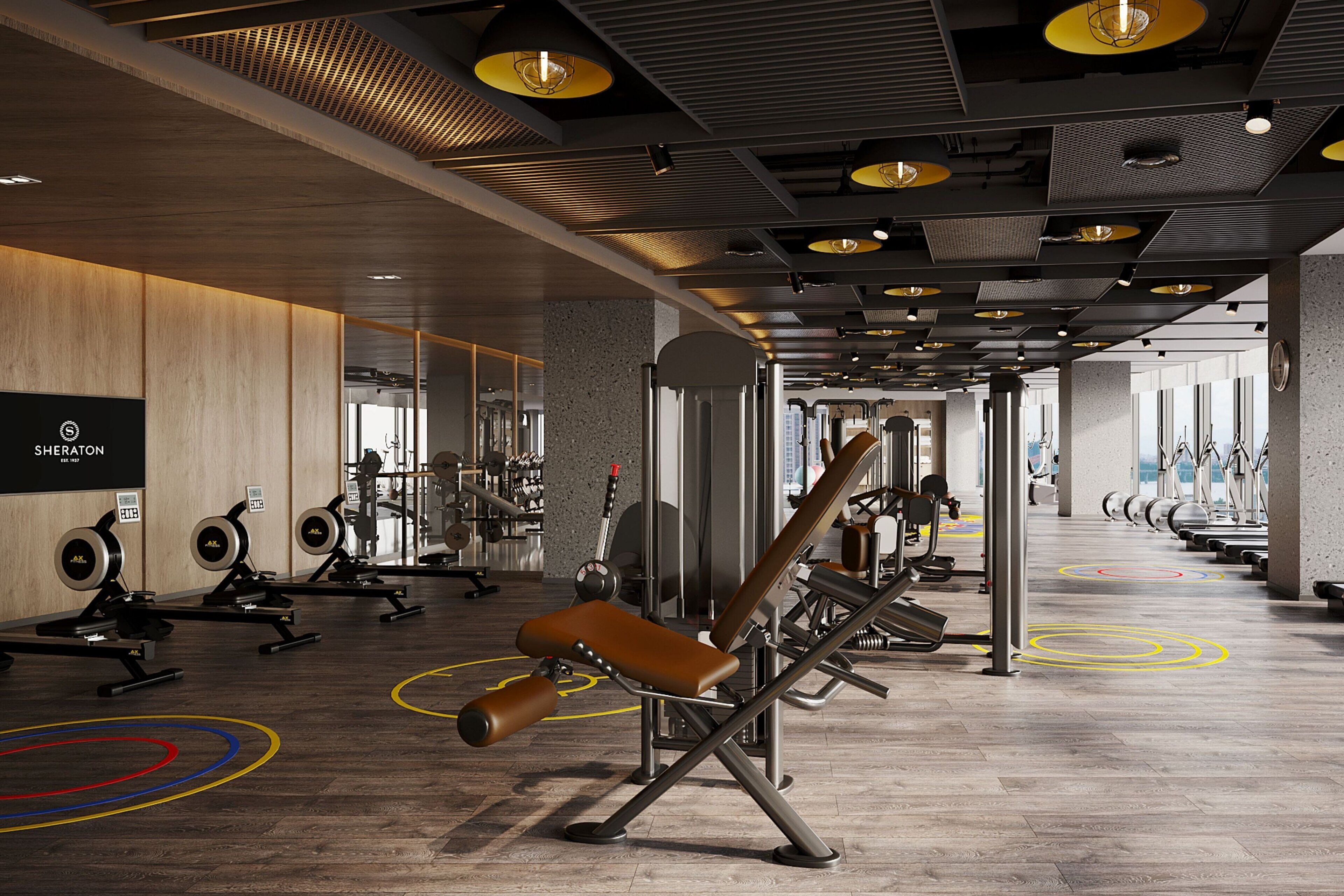 Ett modernt gym med olika typer av träningsutrustning, inklusive styrketräningsmaskiner och konditionsmaskiner.